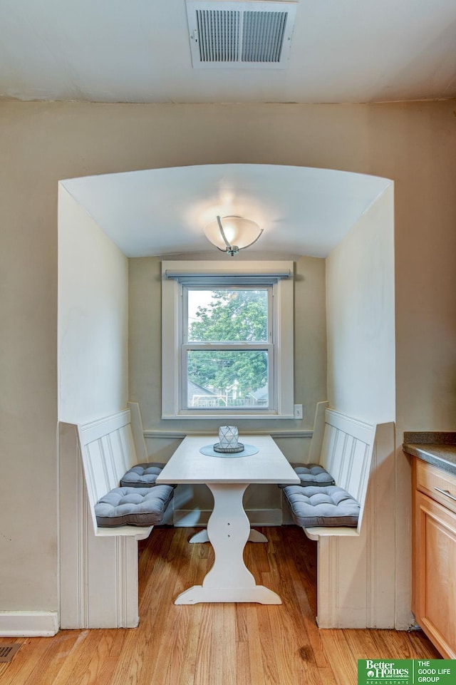 406 S 49th St, Omaha, NE 68132 - dining space with breakfast area, a wainscoted wall, light wood-style floors, and a decorative wall