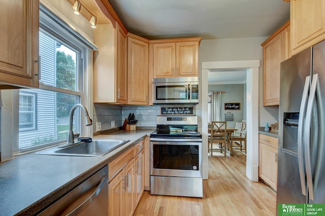 406 S 49th St, Omaha, NE 68132 - kitchen with stainless steel appliances, a sink, light wood-style flooring, and light brown cabinets