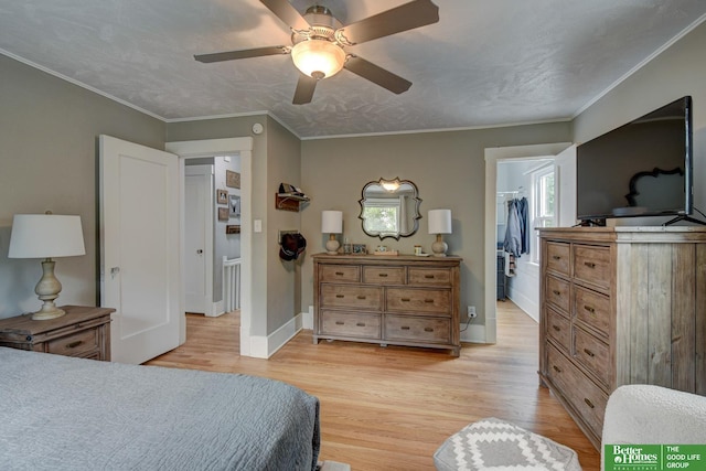 406 S 49th St, Omaha, NE 68132 - bedroom featuring light wood-style flooring, a walk in closet, a ceiling fan, baseboards, and crown molding