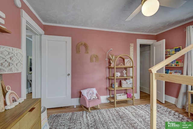 406 S 49th St, Omaha, NE 68132 - bedroom with wood finished floors, a ceiling fan, ornamental molding, and baseboards