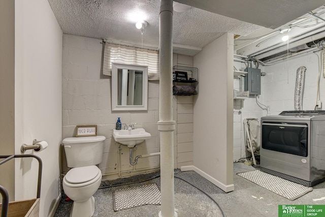406 S 49th St, Omaha, NE 68132 - bathroom featuring washer / clothes dryer, concrete block wall, toilet, electric panel, and a sink