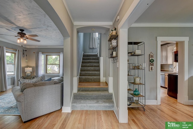 406 S 49th St, Omaha, NE 68132 - stairs with wood finished floors, ornamental molding, a ceiling fan, baseboards, and arched walkways