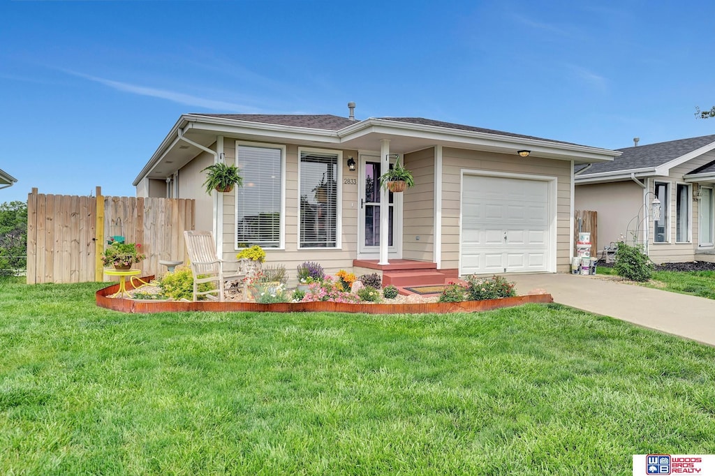 2833 NW 55th St, Lincoln, NE 68524 - ranch-style house with an attached garage and driveway