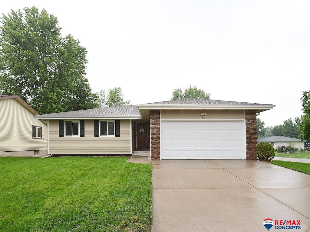4201 Jacquelyn Dr, Lincoln, NE 68516 - ranch-style house with driveway, a garage, a front lawn, and brick siding