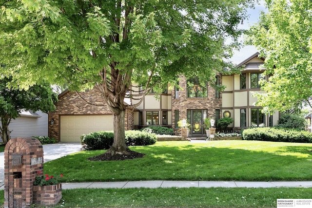 12829 Izard St, Omaha, NE 68154 - view of front of property featuring a garage, a front yard, stucco siding, brick siding, and concrete driveway