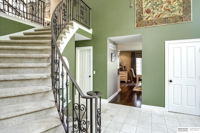 12829 Izard St, Omaha, NE 68154 - stairway featuring a towering ceiling and baseboards