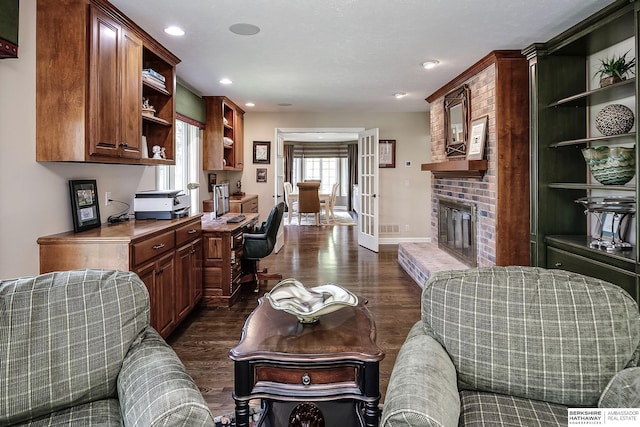 12829 Izard St, Omaha, NE 68154 - living area featuring dark wood-type flooring, recessed lighting, a brick fireplace, and baseboards