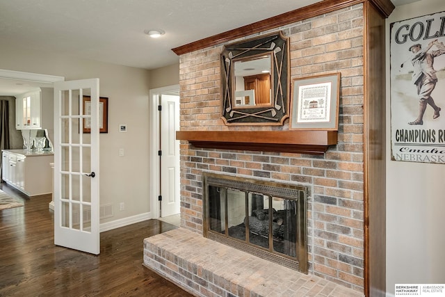 12829 Izard St, Omaha, NE 68154 - unfurnished living room with dark wood-type flooring, a fireplace, baseboards, and french doors