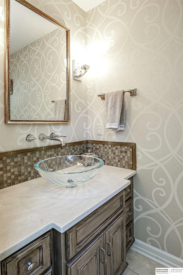 12829 Izard St, Omaha, NE 68154 - bathroom with vanity, backsplash, and tile patterned flooring