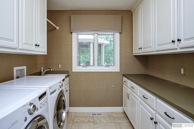 12829 Izard St, Omaha, NE 68154 - washroom featuring cabinet space, independent washer and dryer, and baseboards