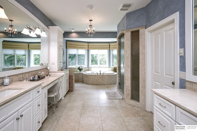 12829 Izard St, Omaha, NE 68154 - bathroom with a chandelier, a bath, vanity, and tasteful backsplash