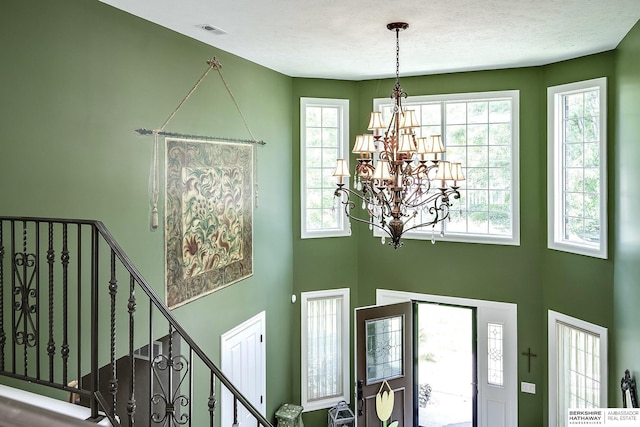 12829 Izard St, Omaha, NE 68154 - foyer entrance with a chandelier, a high ceiling, and plenty of natural light