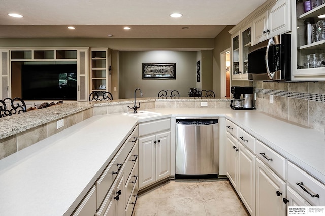 12829 Izard St, Omaha, NE 68154 - kitchen with appliances with stainless steel finishes, a sink, light countertops, recessed lighting, and glass insert cabinets