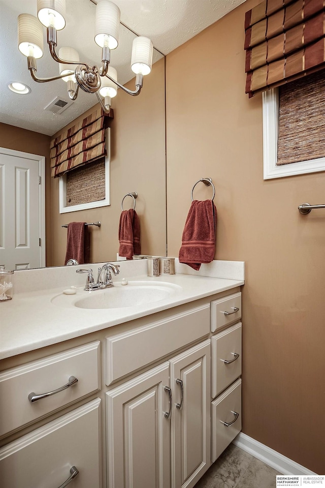 12829 Izard St, Omaha, NE 68154 - bathroom featuring vanity, a chandelier, and baseboards