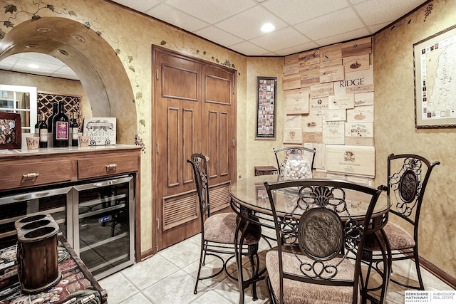 12829 Izard St, Omaha, NE 68154 - dining space featuring a dry bar, beverage cooler, light tile patterned floors, a textured wall, and recessed lighting