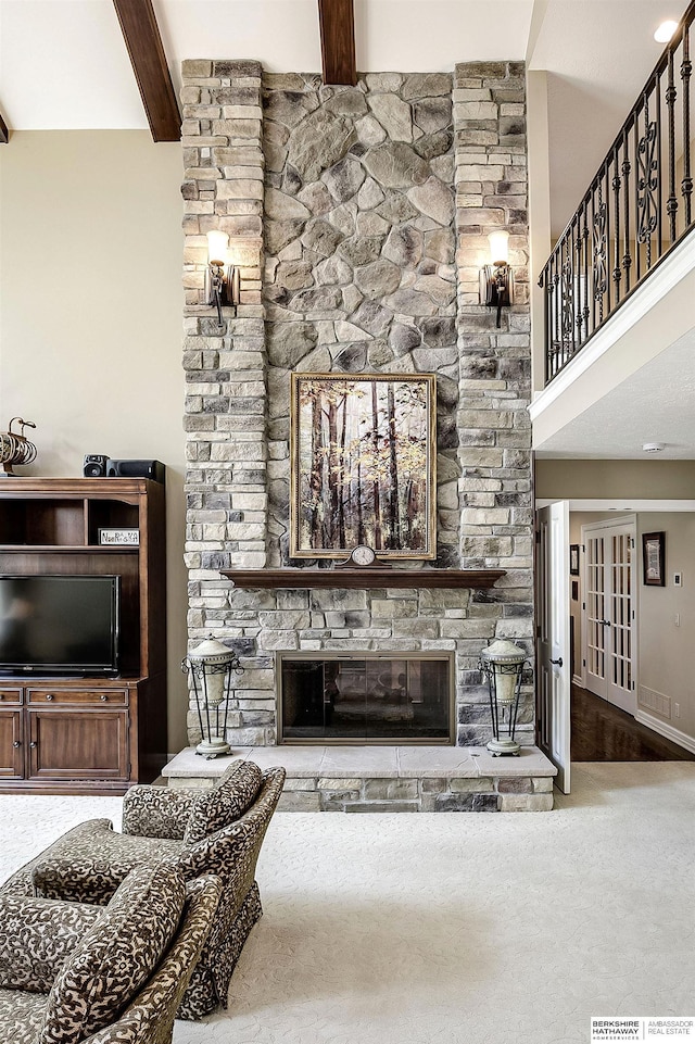 12829 Izard St, Omaha, NE 68154 - carpeted living room with a fireplace, beamed ceiling, french doors, and a high ceiling