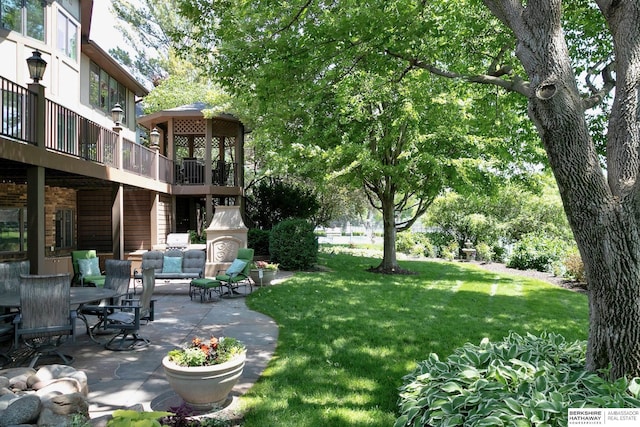 12829 Izard St, Omaha, NE 68154 - view of grassy yard featuring a patio area and an outdoor hangout area
