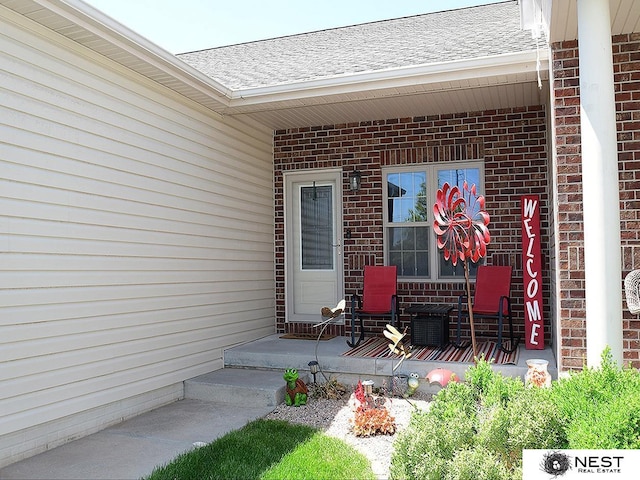 7615 Greycliff Dr, Lincoln, NE 68516 - entrance to property featuring brick siding, a porch, and a shingled roof