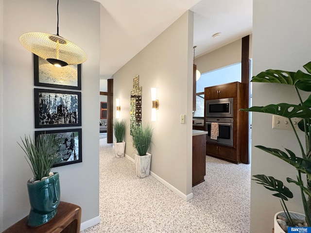 5941 Margo Dr, Lincoln, NE 68510 - corridor featuring baseboards and dark aggregate flooring
