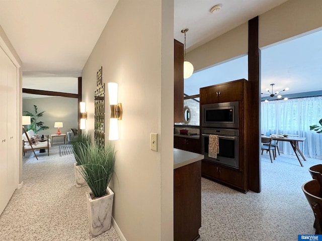 5941 Margo Dr, Lincoln, NE 68510 - hall with plenty of natural light, baseboards, and a chandelier