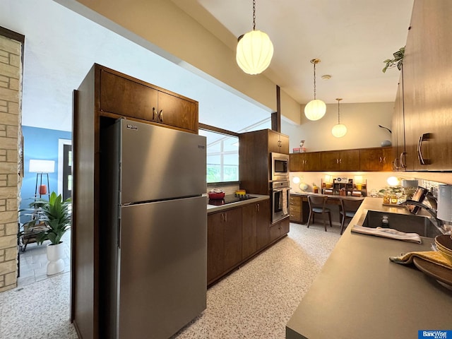 5941 Margo Dr, Lincoln, NE 68510 - kitchen featuring appliances with stainless steel finishes, dark speckled floor, a sink, pendant lighting, and dark brown cabinets