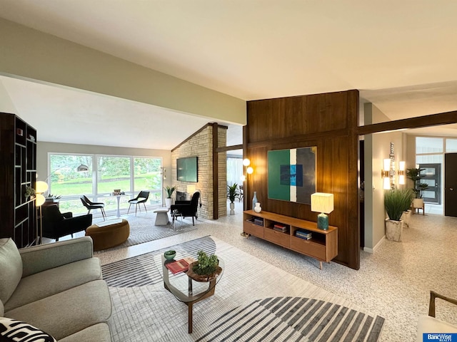 5941 Margo Dr, Lincoln, NE 68510 - living area featuring dark aggregate flooring, vaulted ceiling, and baseboards