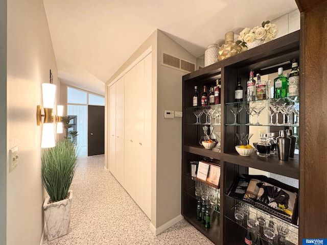 5941 Margo Dr, Lincoln, NE 68510 - hallway featuring speckled floor, vaulted ceiling, and baseboards