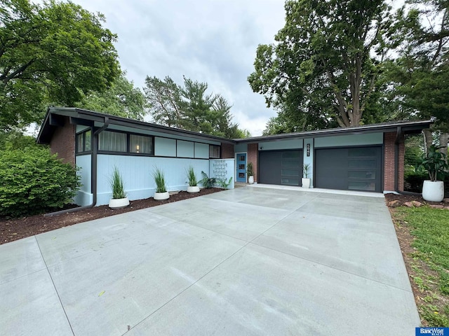 5941 Margo Dr, Lincoln, NE 68510 - mid-century inspired home featuring driveway, an attached garage, and brick siding