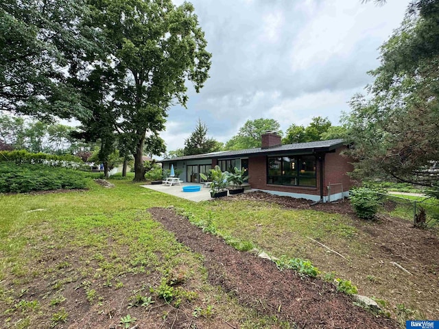 5941 Margo Dr, Lincoln, NE 68510 - view of grassy yard featuring a patio area