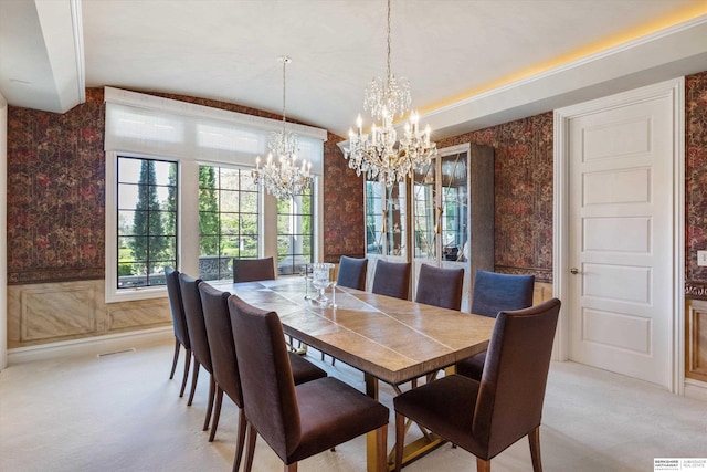 1215 N 136th St, Omaha, NE 68154 - dining area featuring wallpapered walls, a chandelier, light carpet, lofted ceiling, and a wainscoted wall