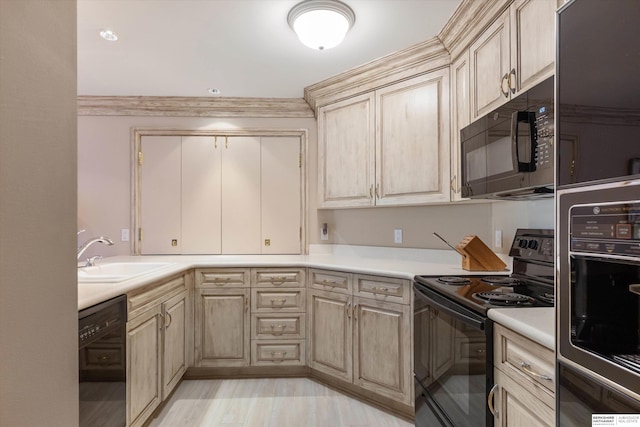 1215 N 136th St, Omaha, NE 68154 - kitchen with black appliances, a sink, light countertops, and light brown cabinets
