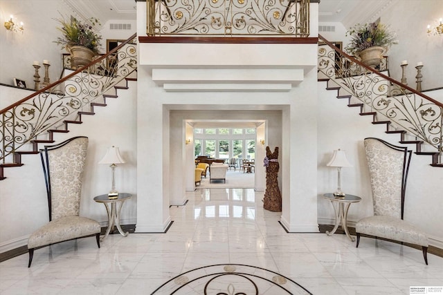 1215 N 136th St, Omaha, NE 68154 - foyer with marble tiled floors, stairs, baseboards, a towering ceiling, and ornamental molding