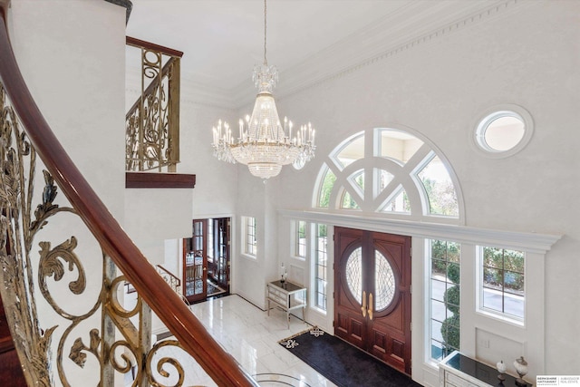 1215 N 136th St, Omaha, NE 68154 - entryway featuring a high ceiling, a chandelier, stairway, plenty of natural light, and ornamental molding