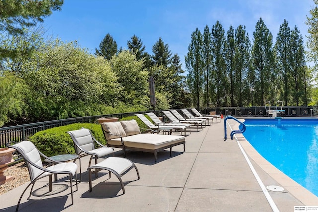 1215 N 136th St, Omaha, NE 68154 - view of swimming pool with a patio area and view of wooded area