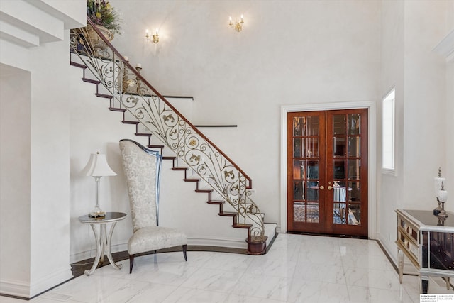 1215 N 136th St, Omaha, NE 68154 - foyer featuring french doors, a towering ceiling, stairway, marble finish flooring, and baseboards