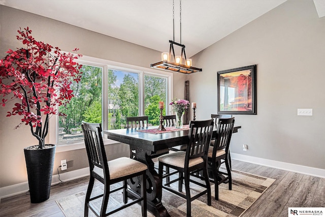 10011 S 184th St, Omaha, NE 68136 - dining area with wood finished floors, baseboards, lofted ceiling, and a chandelier