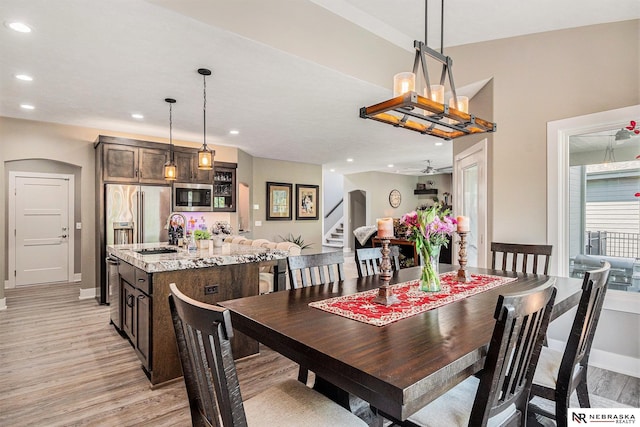 10011 S 184th St, Omaha, NE 68136 - dining space with light wood finished floors, recessed lighting, arched walkways, and baseboards