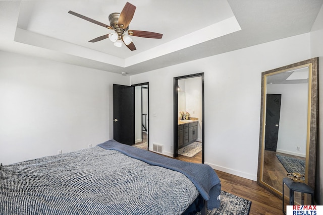 21808 Hilltop Ave, Gretna, NE 68028 - bedroom featuring wood finished floors, a raised ceiling, ceiling fan, and connected bathroom