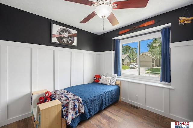 21808 Hilltop Ave, Gretna, NE 68028 - bedroom featuring a decorative wall, wood finished floors, and wainscoting