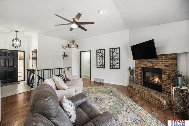 21808 Hilltop Ave, Gretna, NE 68028 - living room featuring a ceiling fan, wood finished floors, a fireplace, and a chandelier