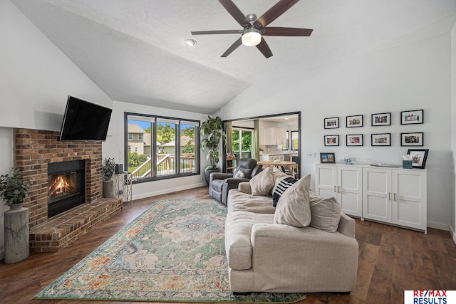 21808 Hilltop Ave, Gretna, NE 68028 - living area with vaulted ceiling, a ceiling fan, a fireplace, and dark wood finished floors