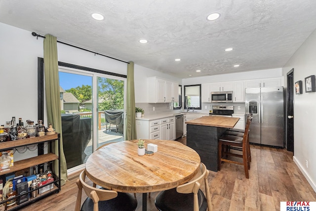 21808 Hilltop Ave, Gretna, NE 68028 - dining area featuring recessed lighting, wood finished floors, and a textured ceiling