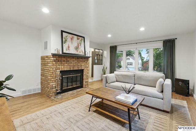 6236 Poppleton Ave, Omaha, NE 68106 - living room featuring light wood-style floors, recessed lighting, baseboards, and a brick fireplace