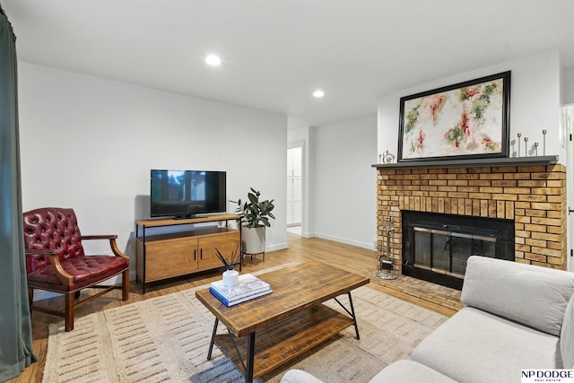 6236 Poppleton Ave, Omaha, NE 68106 - living area featuring wood finished floors, recessed lighting, baseboards, and a fireplace