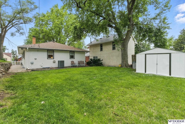 6236 Poppleton Ave, Omaha, NE 68106 - back of house with central AC unit, a chimney, and a lawn