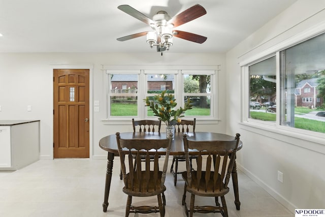 6236 Poppleton Ave, Omaha, NE 68106 - dining area with a ceiling fan, baseboards, and light tile patterned floors