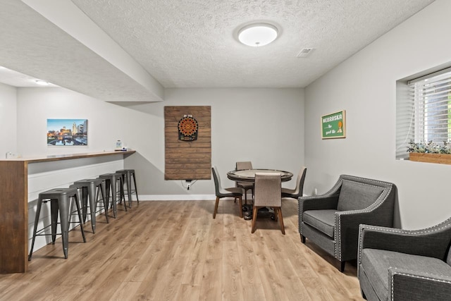 16325 Erskine St, Omaha, NE 68116 - dining area with a textured ceiling, wood finished floors, and baseboards