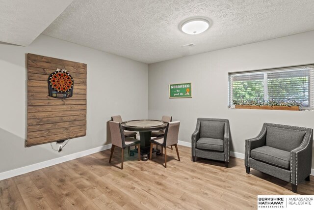 16325 Erskine St, Omaha, NE 68116 - dining room with light wood-type flooring, a textured ceiling, and baseboards