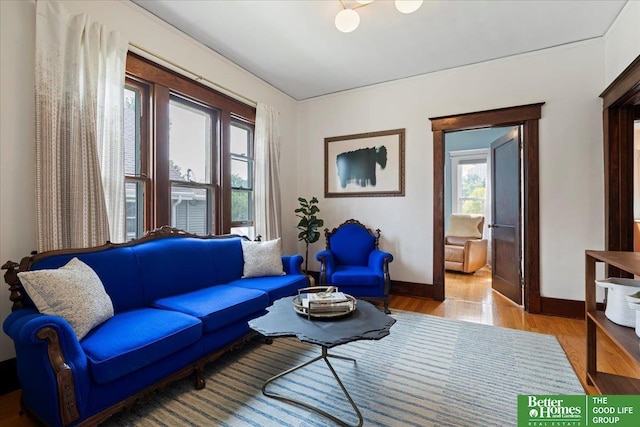 816 S 49th St, Omaha, NE 68106 - living room with healthy amount of natural light, baseboards, and wood finished floors