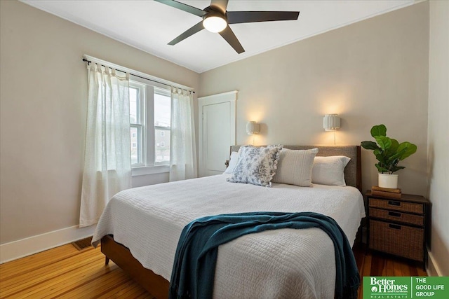 816 S 49th St, Omaha, NE 68106 - bedroom with baseboards, wood finished floors, and a ceiling fan